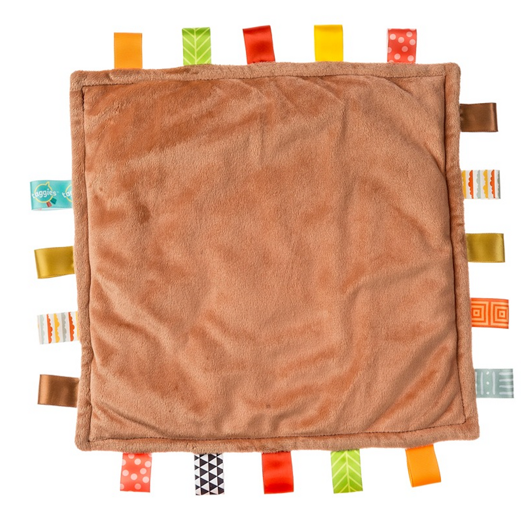 The plush backside of Taggies Original Rooster blanket in a deep rust velour. 