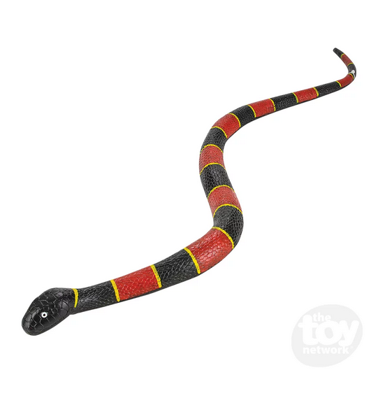The red, black and yellow ringed rubber snake stretched out with it's head facing the camera. 