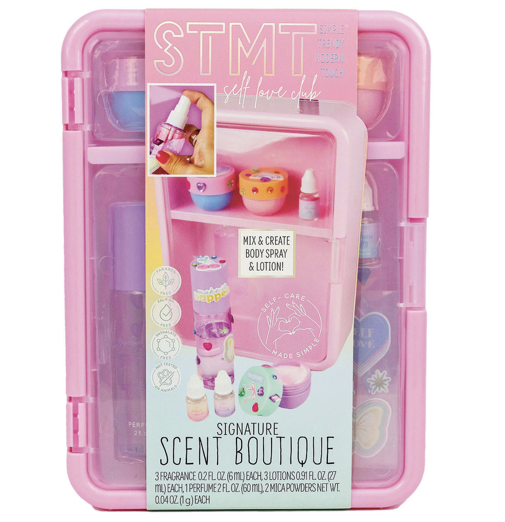 A pink storage container with compartments that holds all of the supplies included in the STMT Signature Scent Boutique set. 