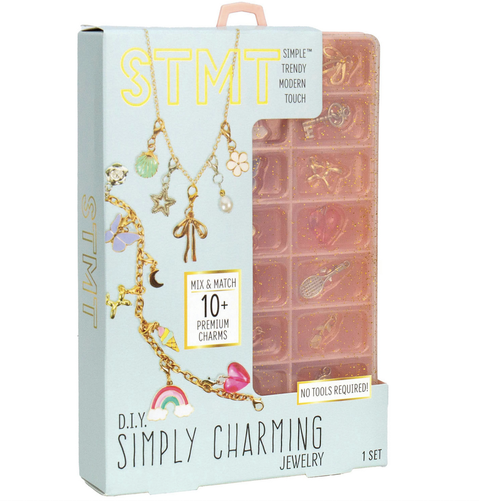 The STMT Simply Charming Jewelry kit with storage case that has lots of compartments packaged with a cardboard sleeve that has pretty charm jewelry pictured on the front. 