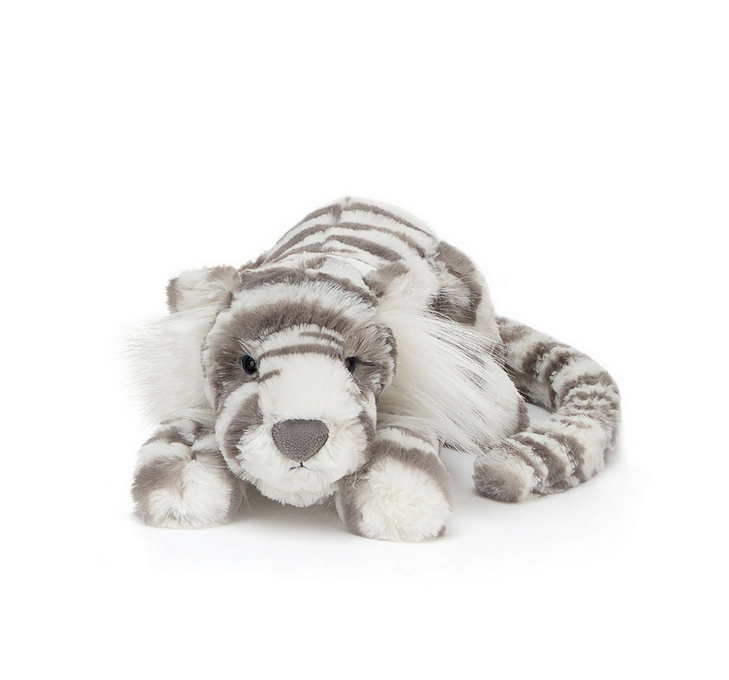 Adorable plush snow tiger lying on it's tummy facing forward. 