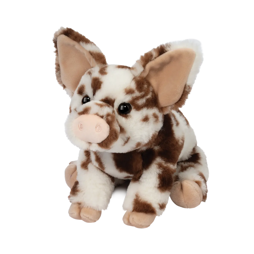 The cutest little cream colored pig with brown spots in a seated position. 