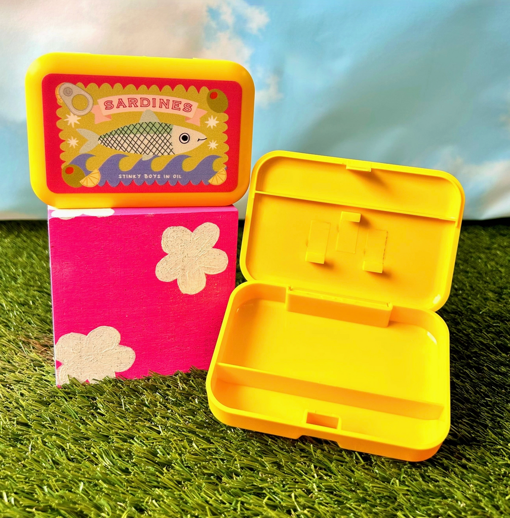 The Sardine box opened to show the internal compartments. 