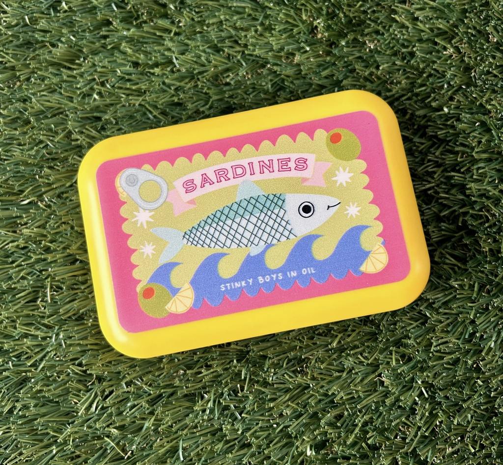 Yellow box with an illustration of a sardine label with a lemon peel and olives. 
