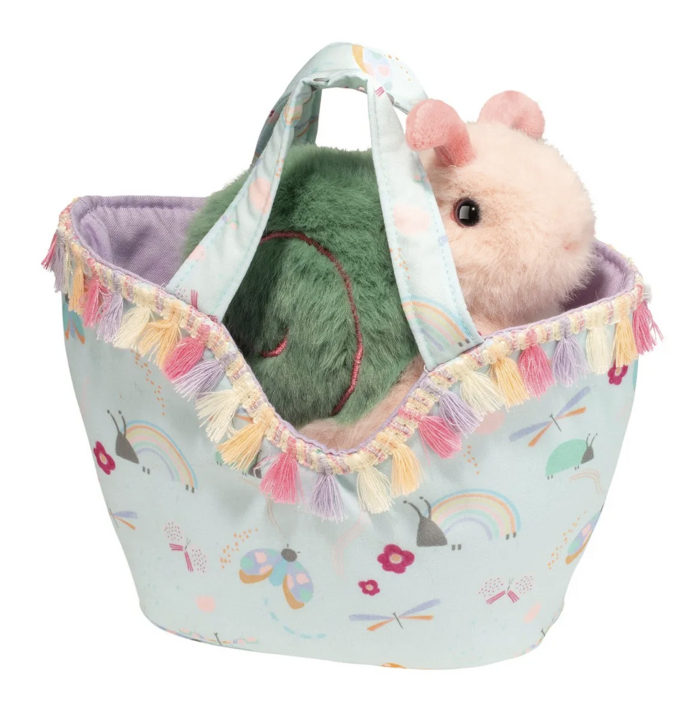 Stuffed animal snail in a purse with fringe and two handles. The purse has rainbows and insects printed on it. 