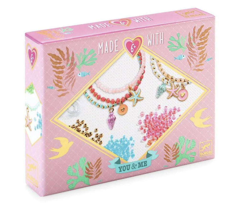 Pink box with illustrations of sea creatures and pictures of the charms included in the Sea Multi Wrap Beads Jewelry Kit.  kit. 