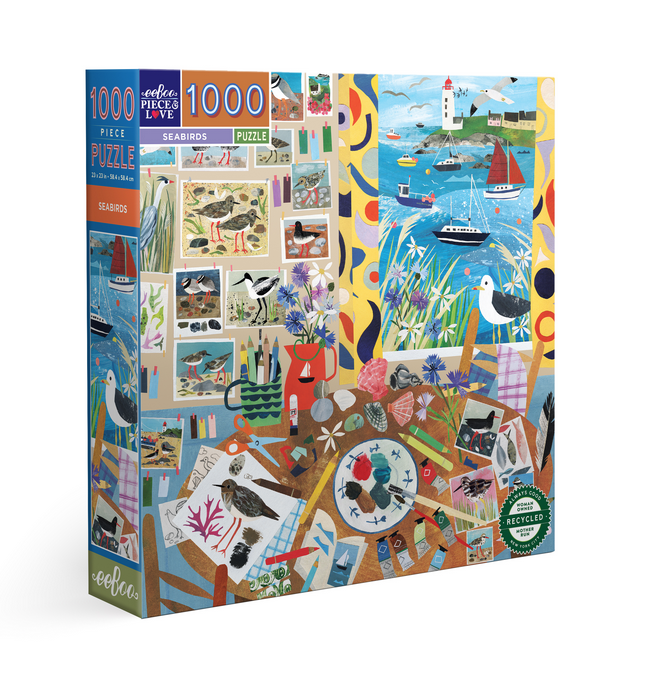 Box for Seabirds 1000 Piece puzzle with image of an artists workspace looking out of the window at the sea at seabirds, boats and a lighthouse. 