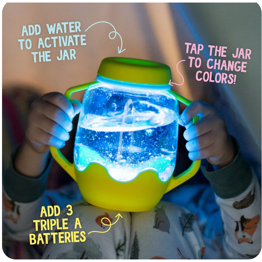 Child in a darkened room holding a lit up sensory play jar. Text reads: Add water to activate the jar, tap the jar to change the color, add 3 AAA batteries.