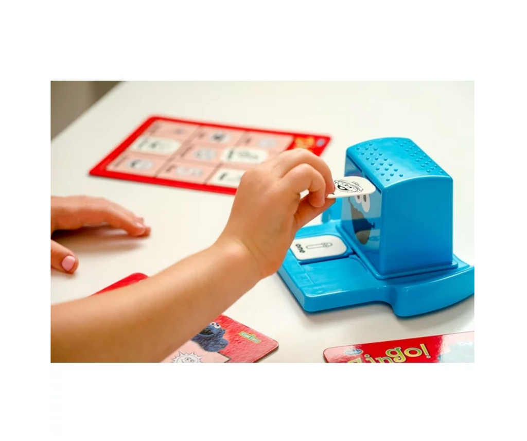 Child putting a word tile in the Cookie Monster word maker.