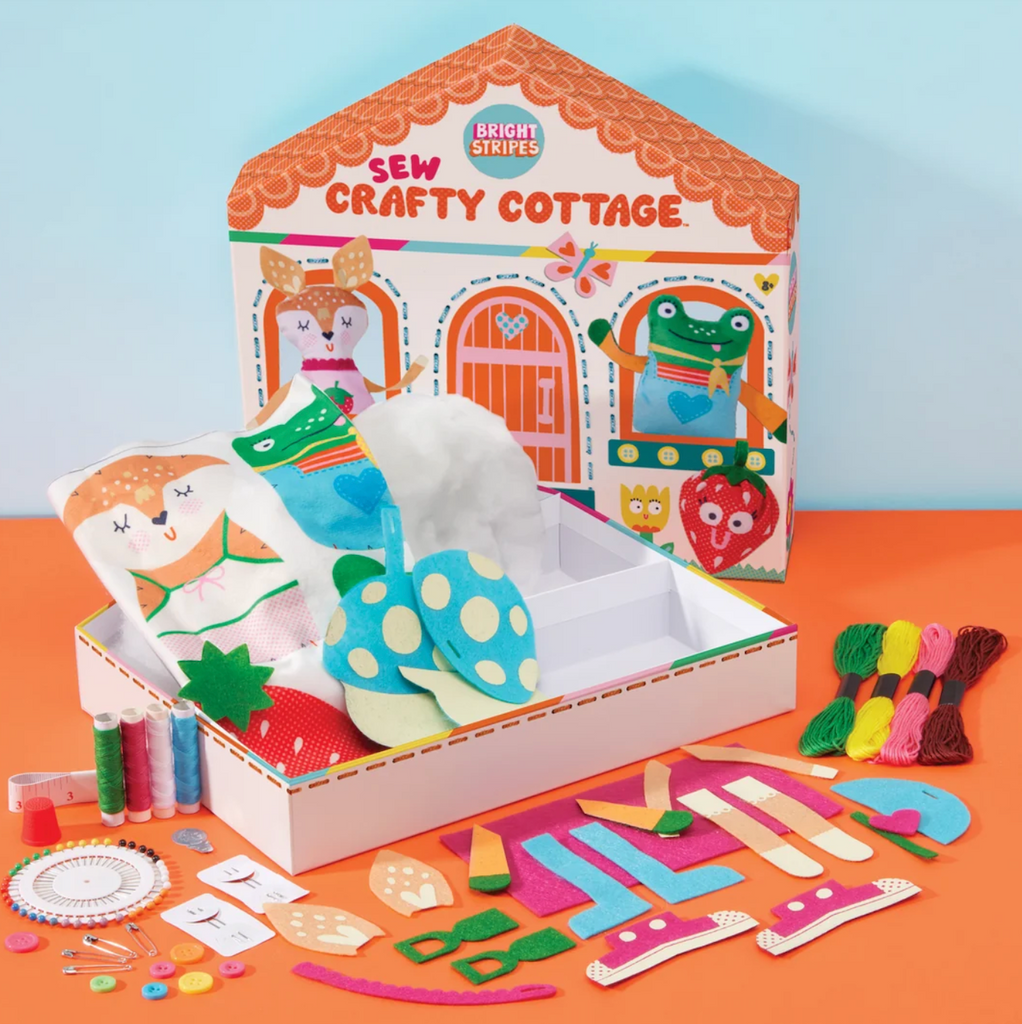 All of the sewing supplies included in the Sew Crafty Cottage kit from Bright Stripes, from thread, buttons, and fabric. 