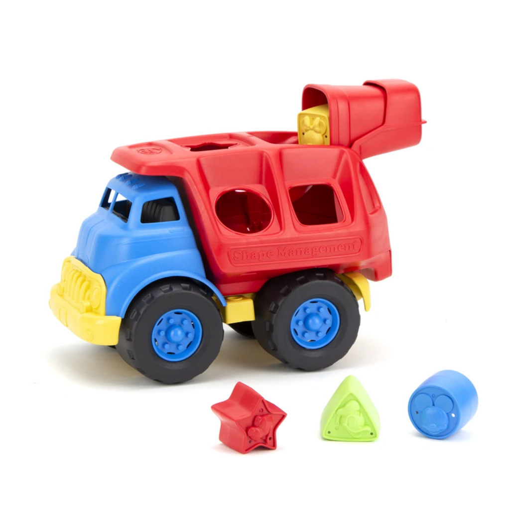 Red, blue and yellow toy truck with shapes cut out of the back. With pieces that are the shapes that fit through the holese. 