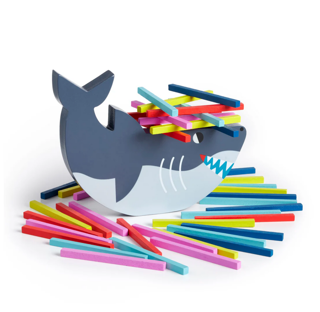 Painted wooden shark and colorful stacking pieces. 