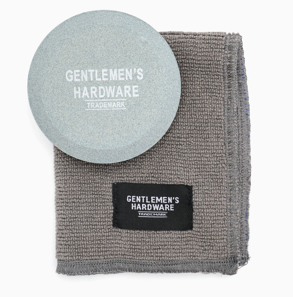 A round sharpening stone and included cloth.
