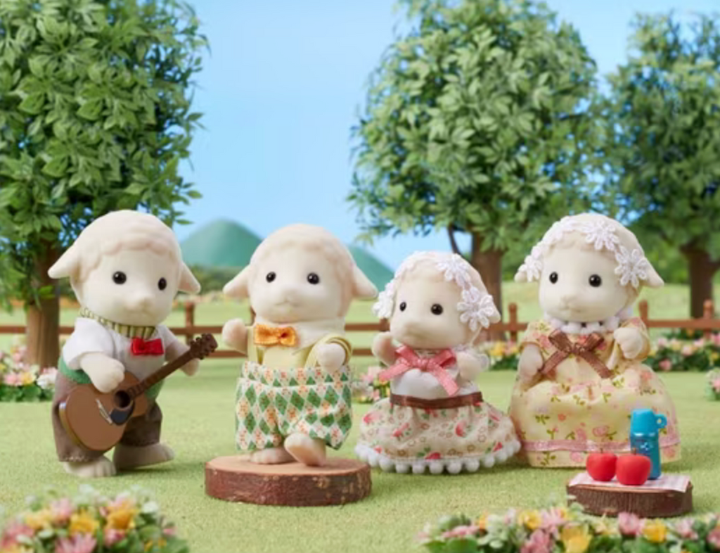 Calico Critters Sheep family set up in a park with the father playing guitar. 