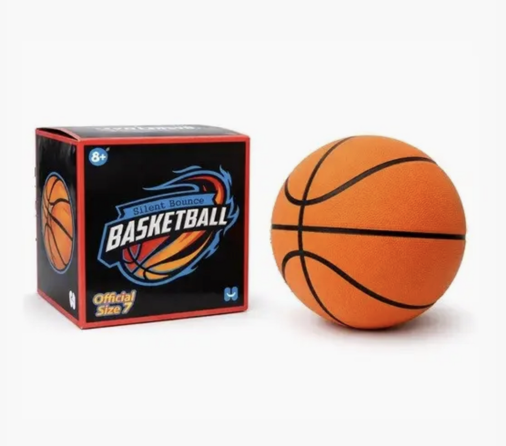 The Silent Bounce Basketball beside the box it comes packaged in. The silent basketball looks just like a regular basketball but is made from a dense, soft, foam which makes it quiet when it bounces. The box is black with a ball in blue flames logo on the front. 