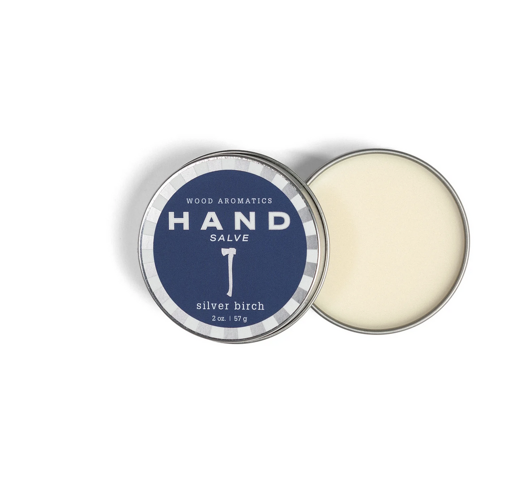 Hand salve tin with a silver axe on a blue background. Text reads: " Wood Aromatics Hand Salve Silver Birch, 2 oz"