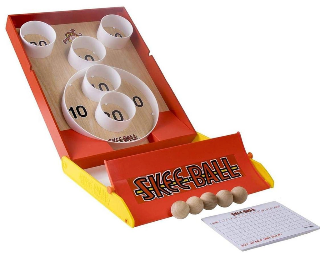 Skee Ball game set up with wooden balls and score card in the foreground. 