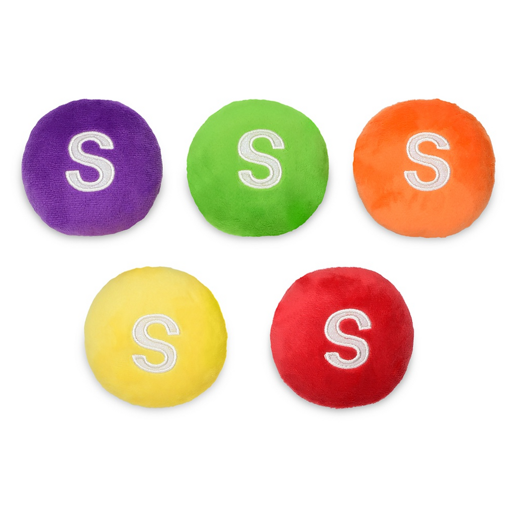 Five plush Skittles candies one purple, green, orange, yellow and red. 