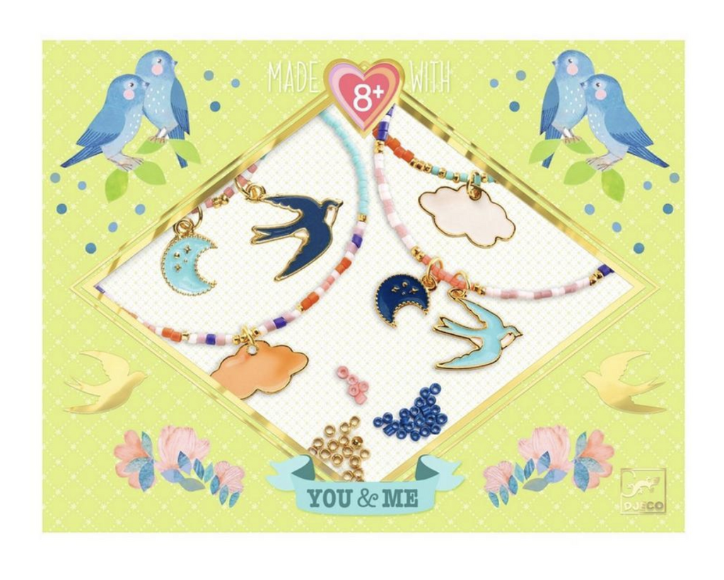 Yellow box with flowers and bird illustrations and pictures of bracelets made using the charms and beads included in the sky bead kit.  