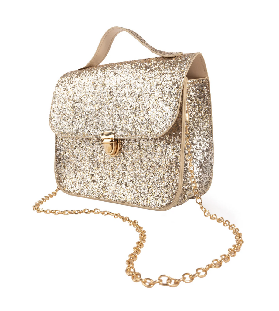 Sparkly gold purse with a gold chain strap, handle on the top, and gold button closure. 