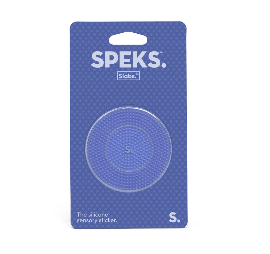 Speks silicone sensory sticker with the static texture which is tiny dots over the entire surface of the round sticker. It is a light periwinkle color, packaged on a clear hang card. 