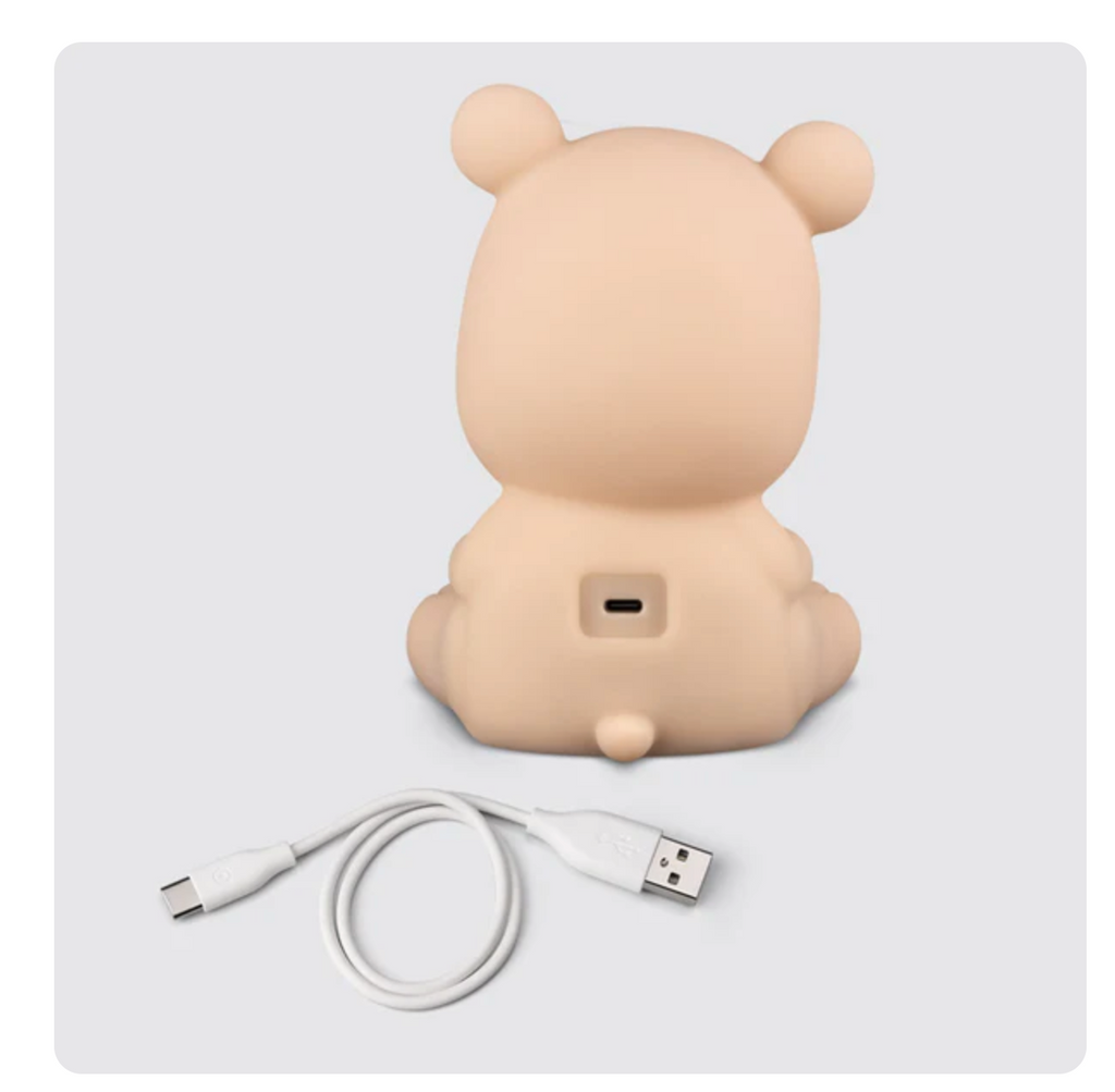 Back of Sleepy Bear character shows input for charging cord with USB charging cord beside it.