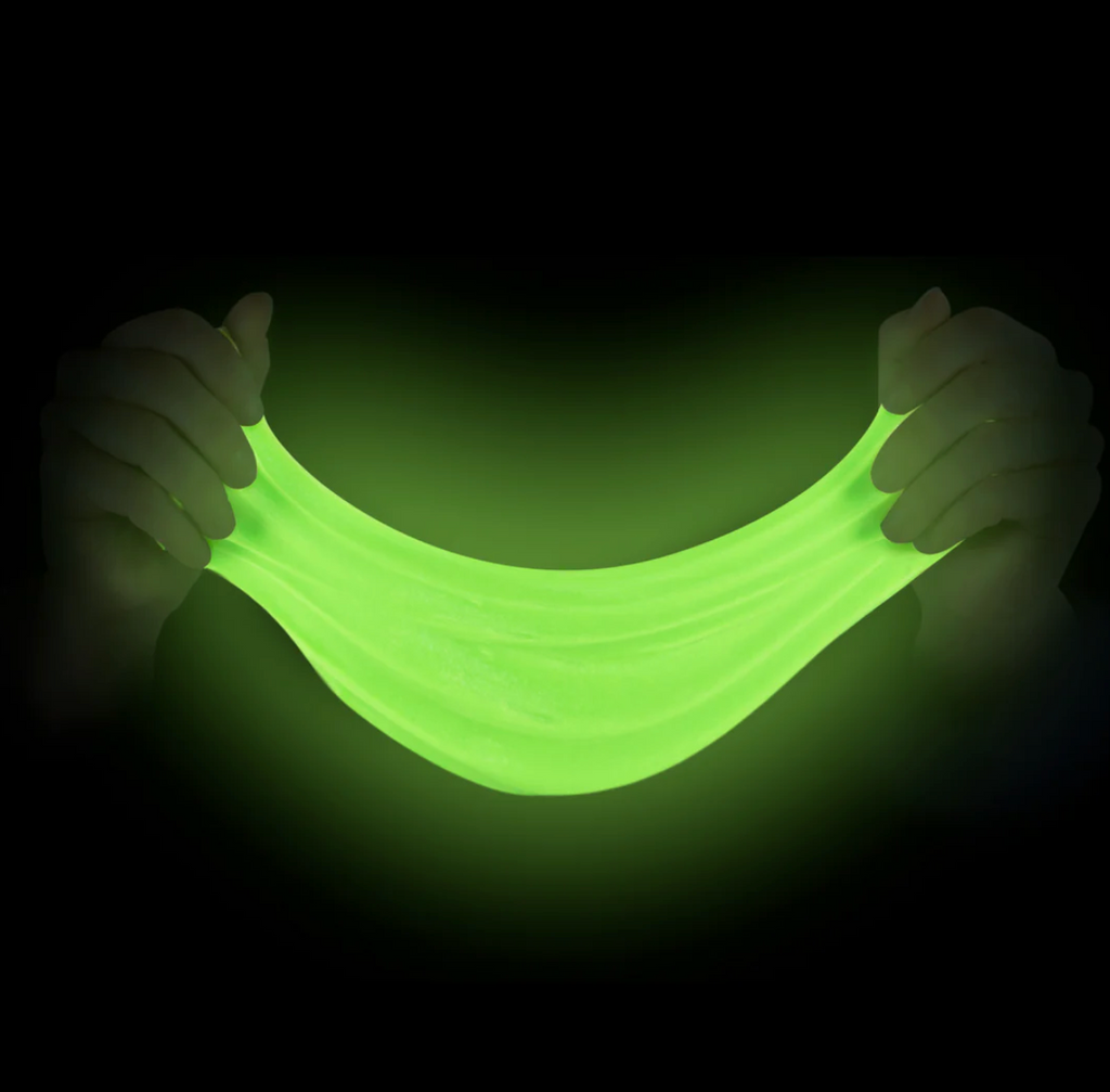 Glowing green slime being held between two hands against a black background