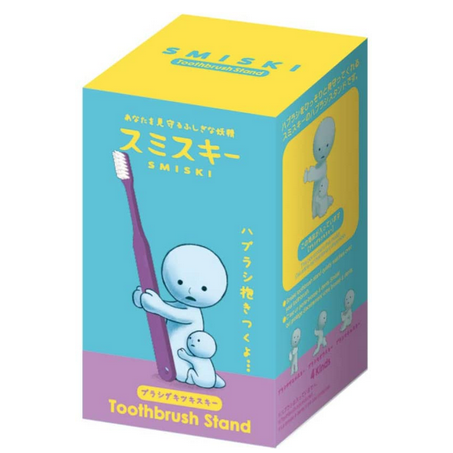 Blue and purple box with an illustration of the Smiski Hugging toothbrush stand. The figure is a Smiski with a baby Smiski figure hugging the leg of the Smiski figure that holds the toothbrush.