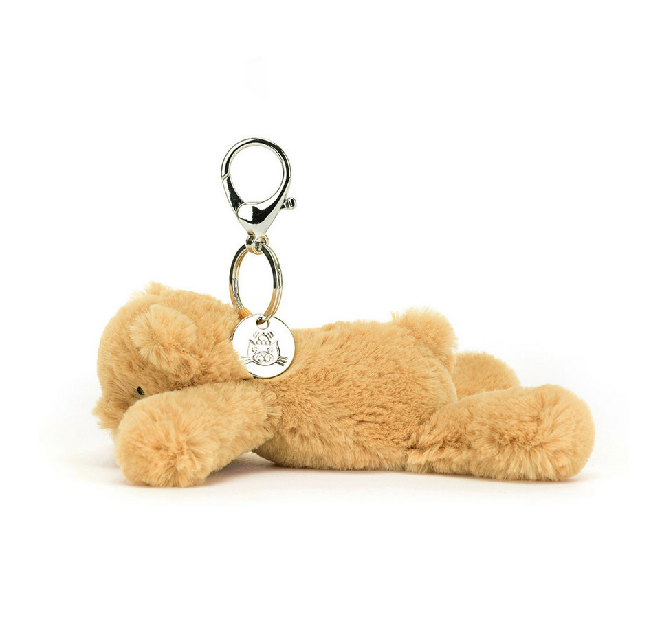 Side view of the Smudge Bear Bag Charm showing the silver clasp and Jellycat signature disc. 