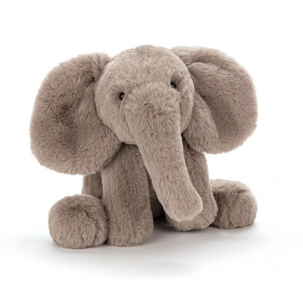 Large plush Smudge Elephant stuffed animal. It's sitting up and facing forward. 