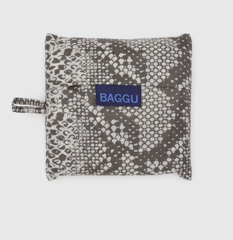 Standard size Baggu reusable bag folded into it's flat storage pouch in the Snakeskin pattern. 