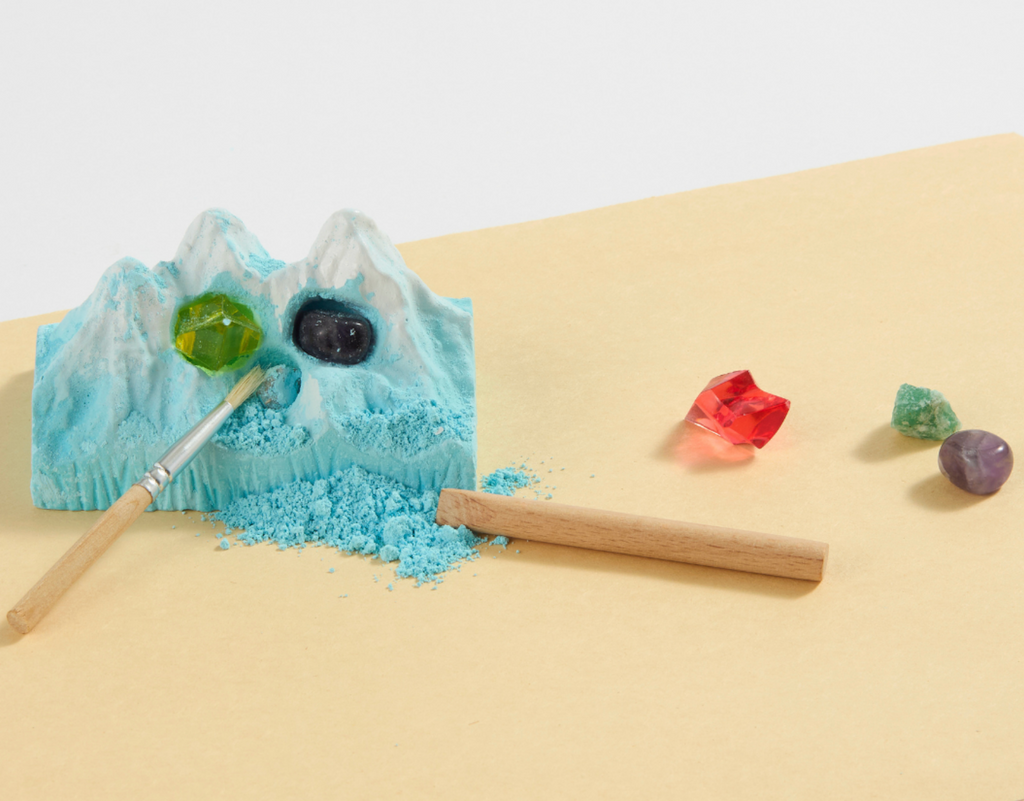 The Snow Mountain after having been chipped away with the wooden chisel tool and crystals that have been dug out.