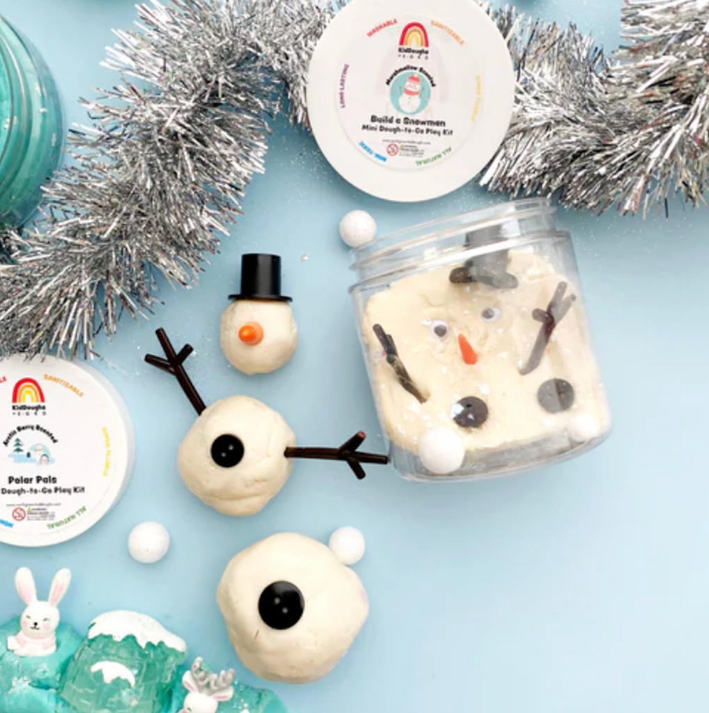 Clear jar with Snowman marshmallow kid dough and accessories to turn it into a snowman. 