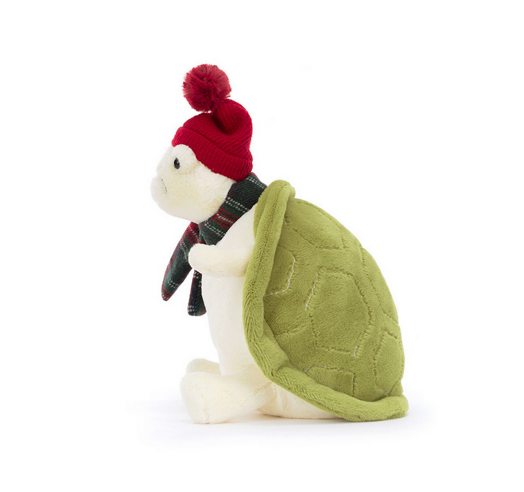 Side view of Snowman Timmy Turtle from Jellycat. You can clearly see his green shell, red knit hat and Christmas plaid scarf. 