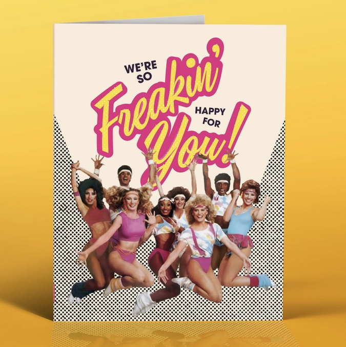 Greeting card with color photo of dancers dressed in 80's style workout clothing jumping on the air that reads "We're so Freakin' Happy for You!"