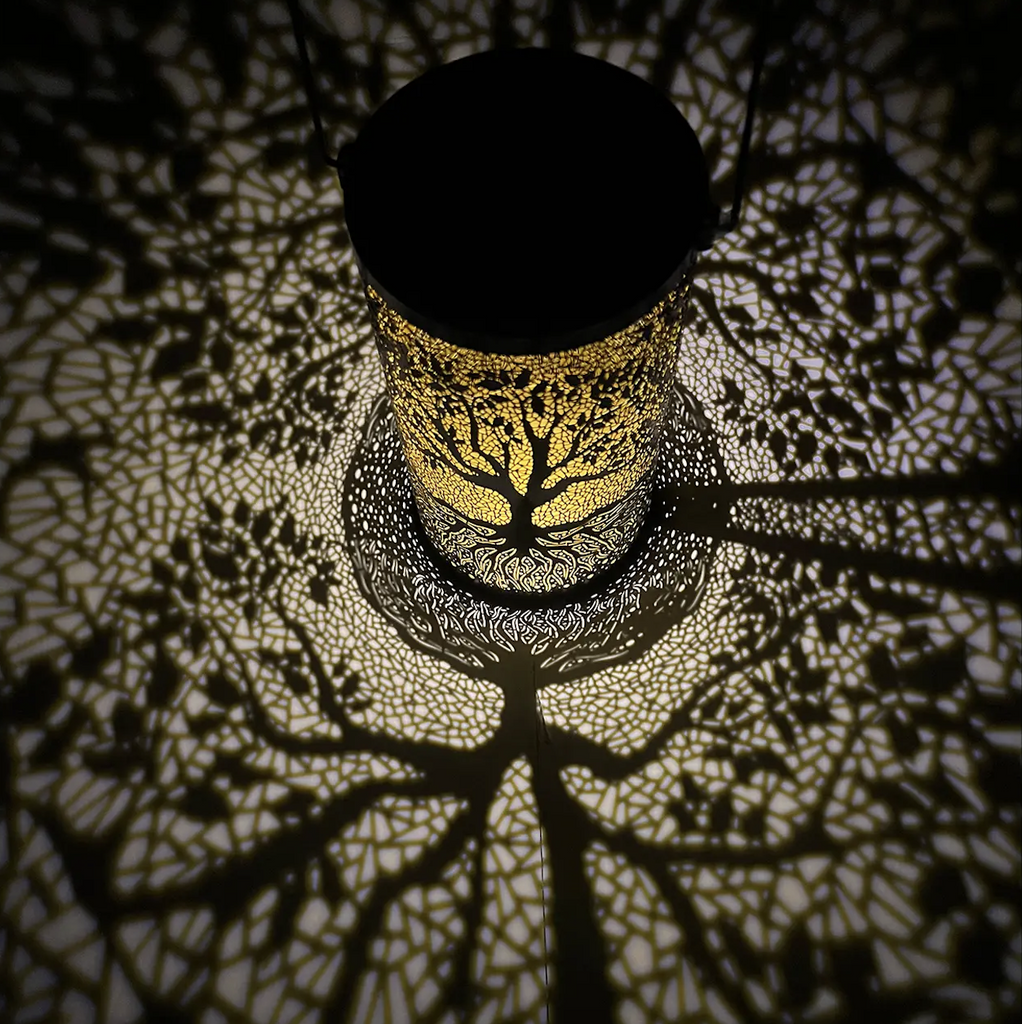 The Solar Garden Lantern Tree illuminated and projecting the beautiful tree pattern on the surrounding floor and walls. 