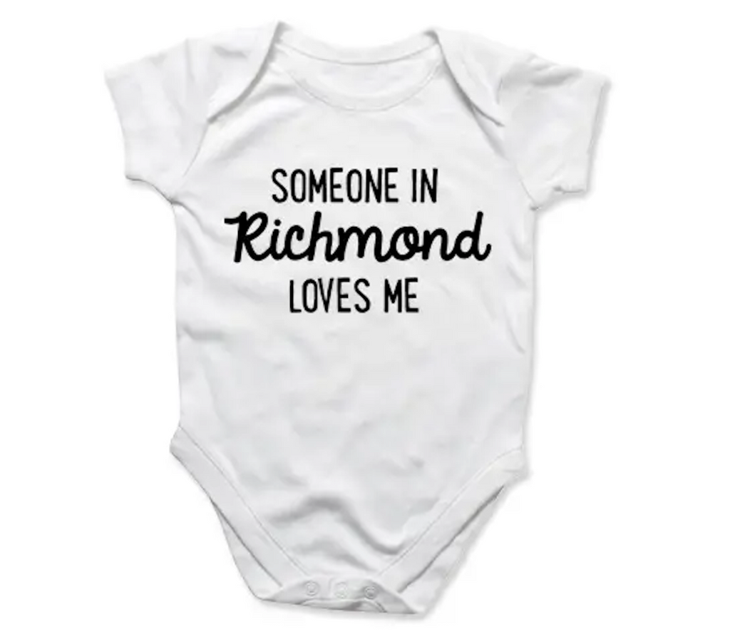 Baby one piece snapsuit that reads "Someone in Richmond Loves Me" in black lettering on a white onesie. 