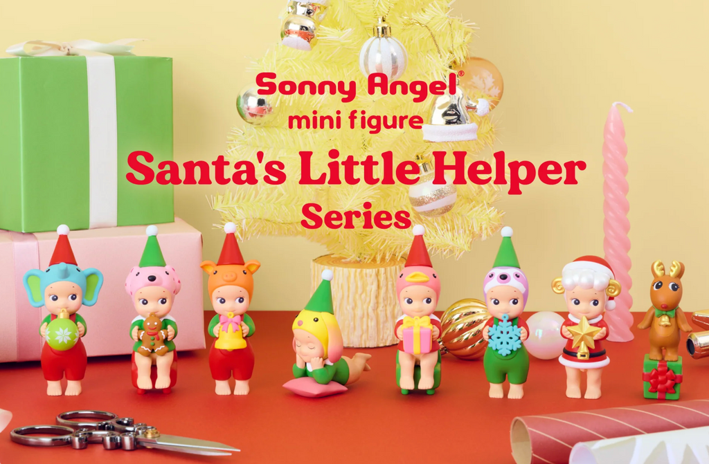 Sonny Angel mini figures in Santa's Little Helper series with Christmas decorations on a table.