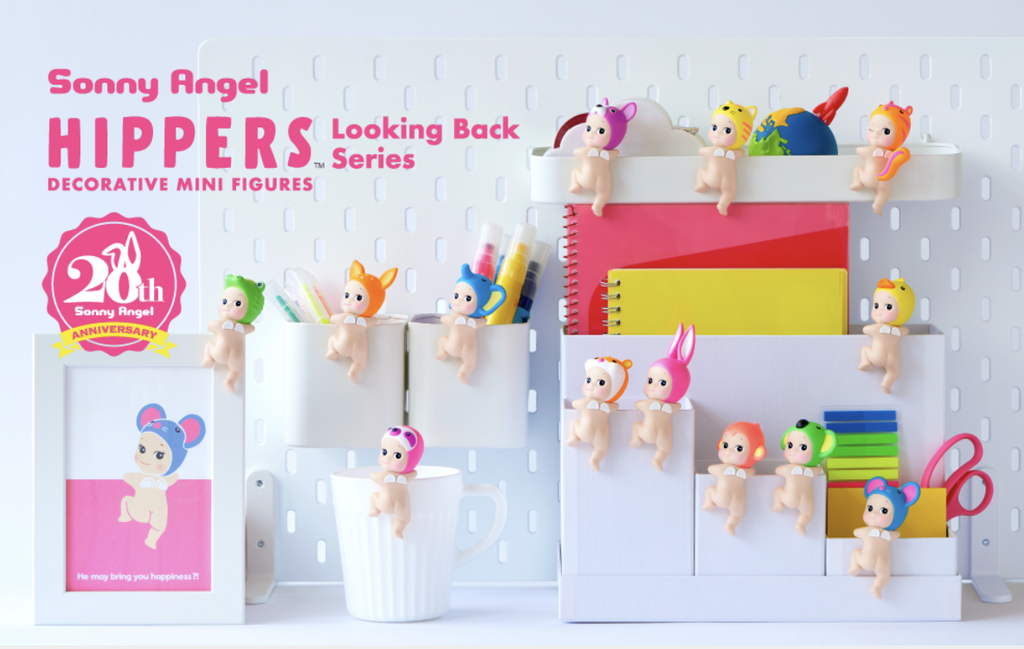 Various Sonny Angel Looking Back figures perched on various desk accessories on a white background.