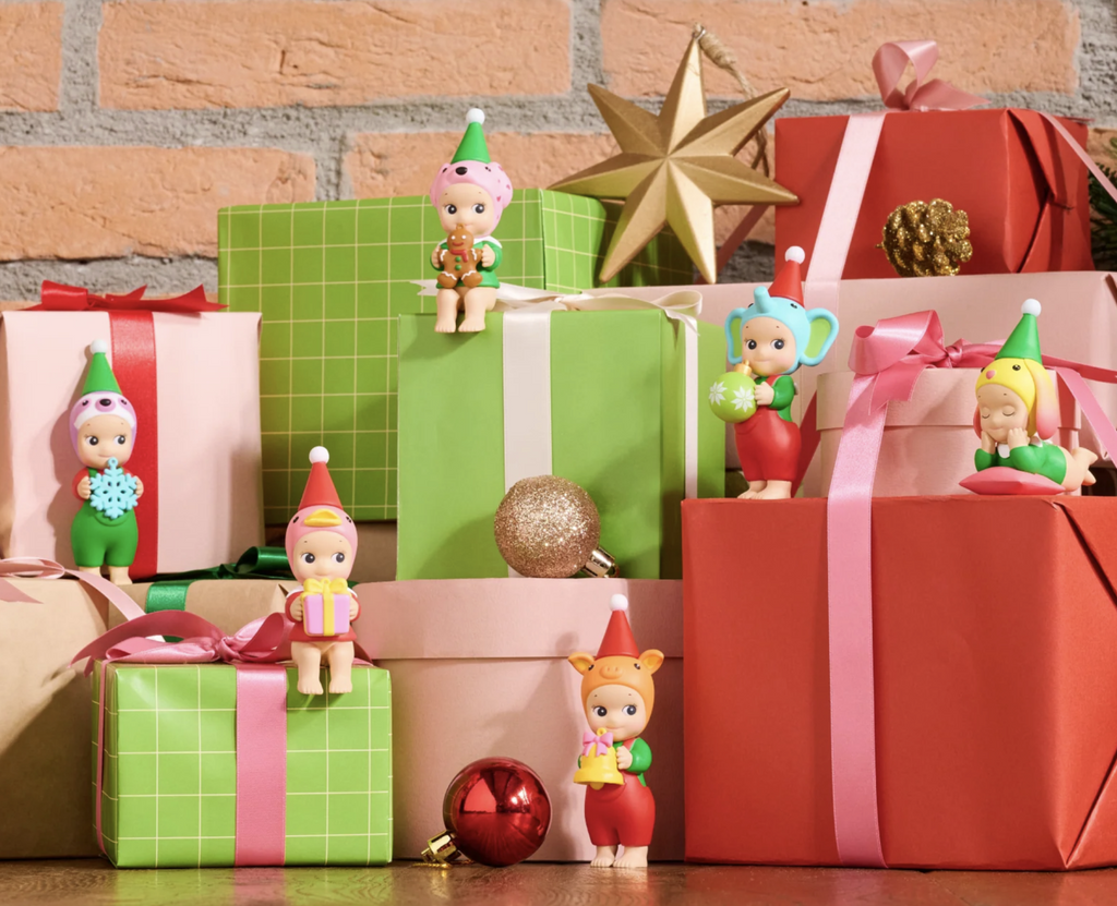 Sonny Angel Santa's Little Helper figures arranged on gift wrapped boxes.