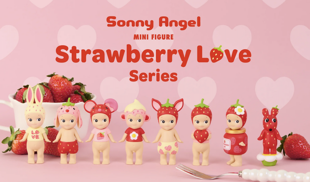 Full Box of the brand new Sonny Angel Strawberry Love Series. Each Sonny Angel figure has a different strawberry themed hat and outfit. The figures are lined up against a pink background. 
