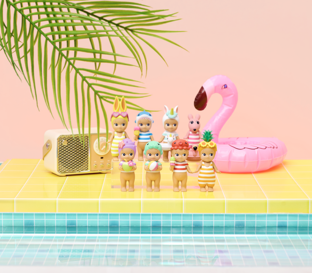 Sonny Angel Sun-Kissed Vacation series figures next to a pool.