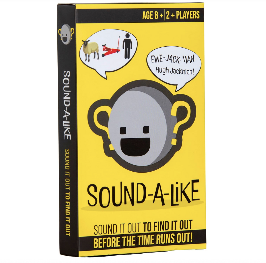 Bright yellow box for the Sound A Like game with a blank face on the cover with question marks at both ears. There is also a world bubble with an example of the type of question that is on the cards for game play. 