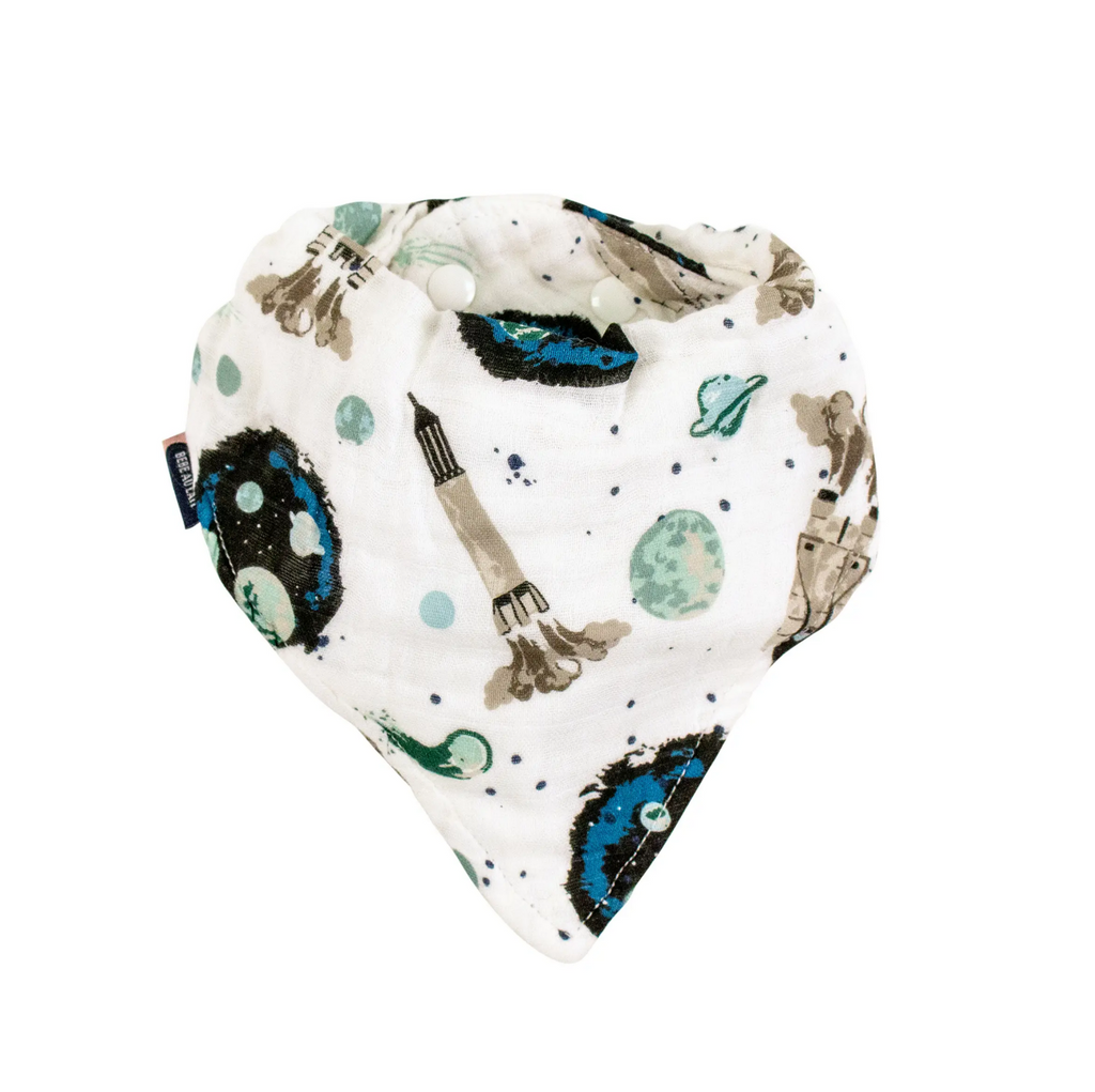 The muslin bandana bib with snaps at the back. The print has a white background with blue and green planets and space rockets.