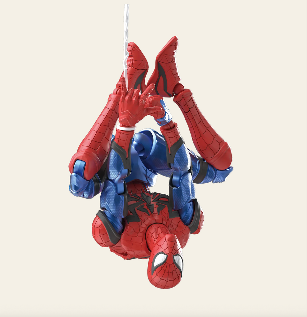 Spider-Man model hanging upside down from a web. 