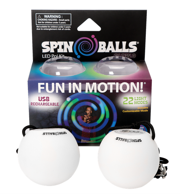 Glow in the dark Spin Balls sitting in front of the box they are packaged in. 