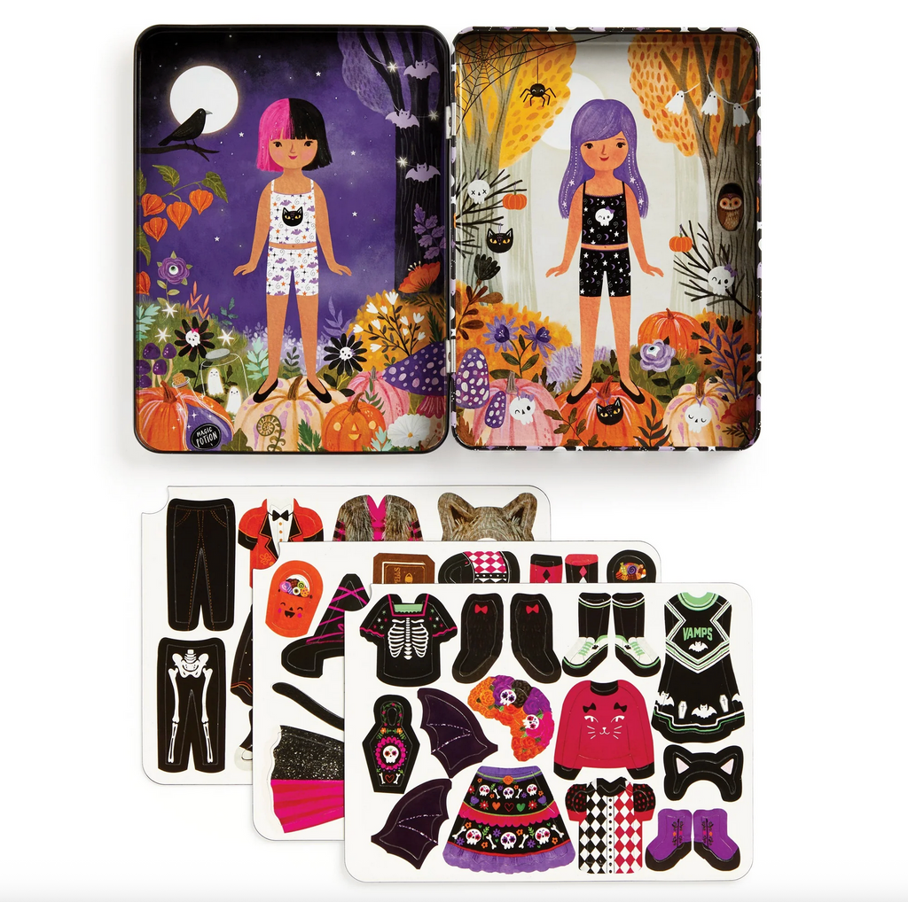 Inside of tin box with 2 different dolls and all their magnetic clothing choices.