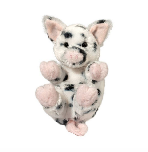 Little plush spotted pig laying on it's back with pink ears, tail and hooves it's black spots make it unbelievably adorable.