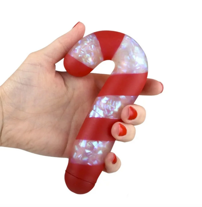 The Squeezy Sparkle Candy Cane being held in a hand. 