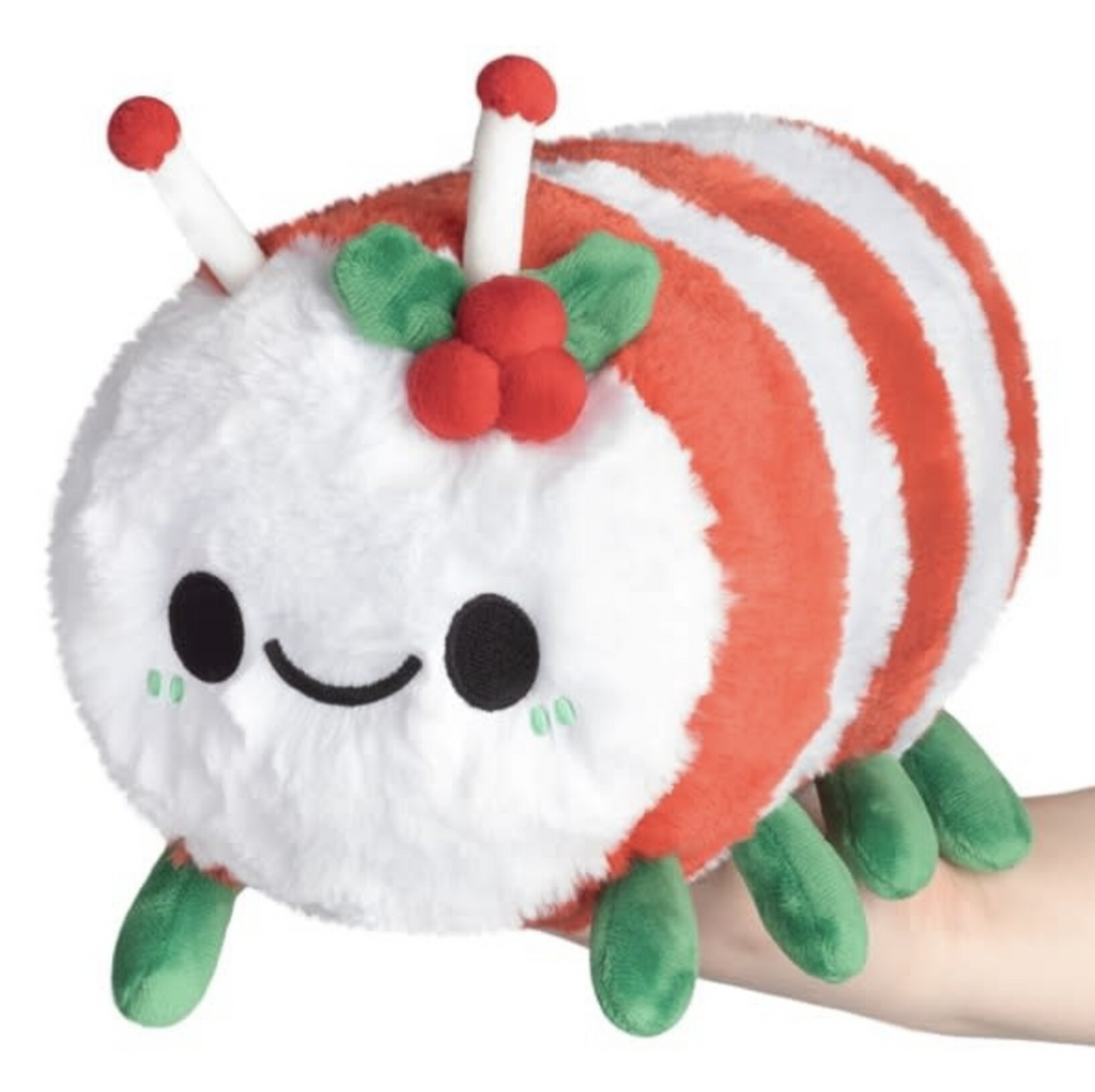 Candy Cane Caterpillar by Squishable with red and white stripes and holly leaves by it's antennae. 